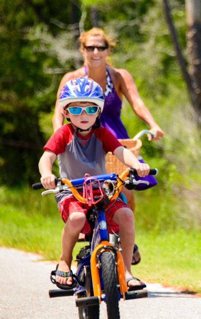 Woman on bike behind child on bike.