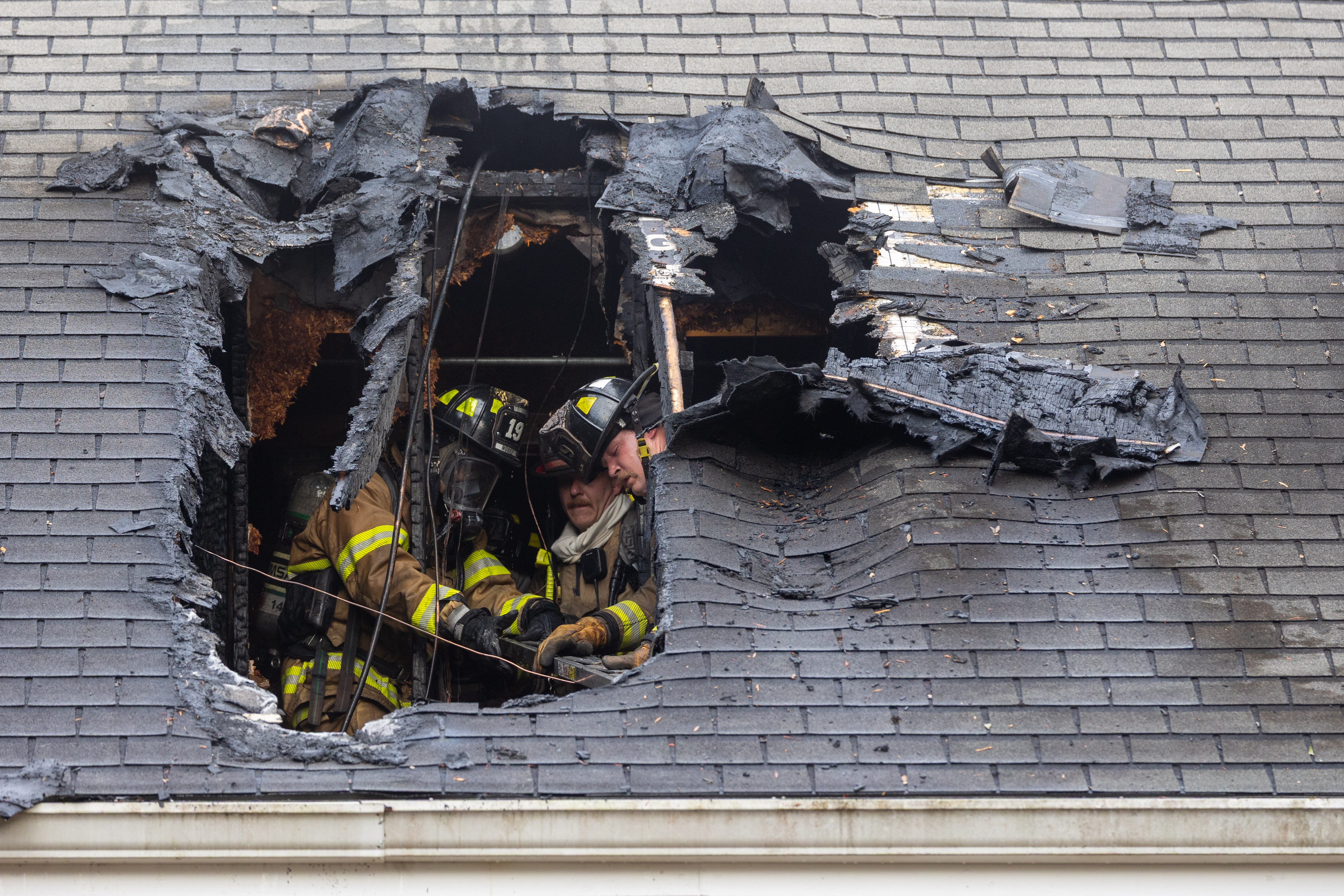 Firefighters work on roof