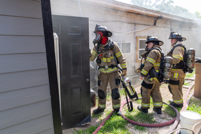 Firefighters work at scene of residential fire