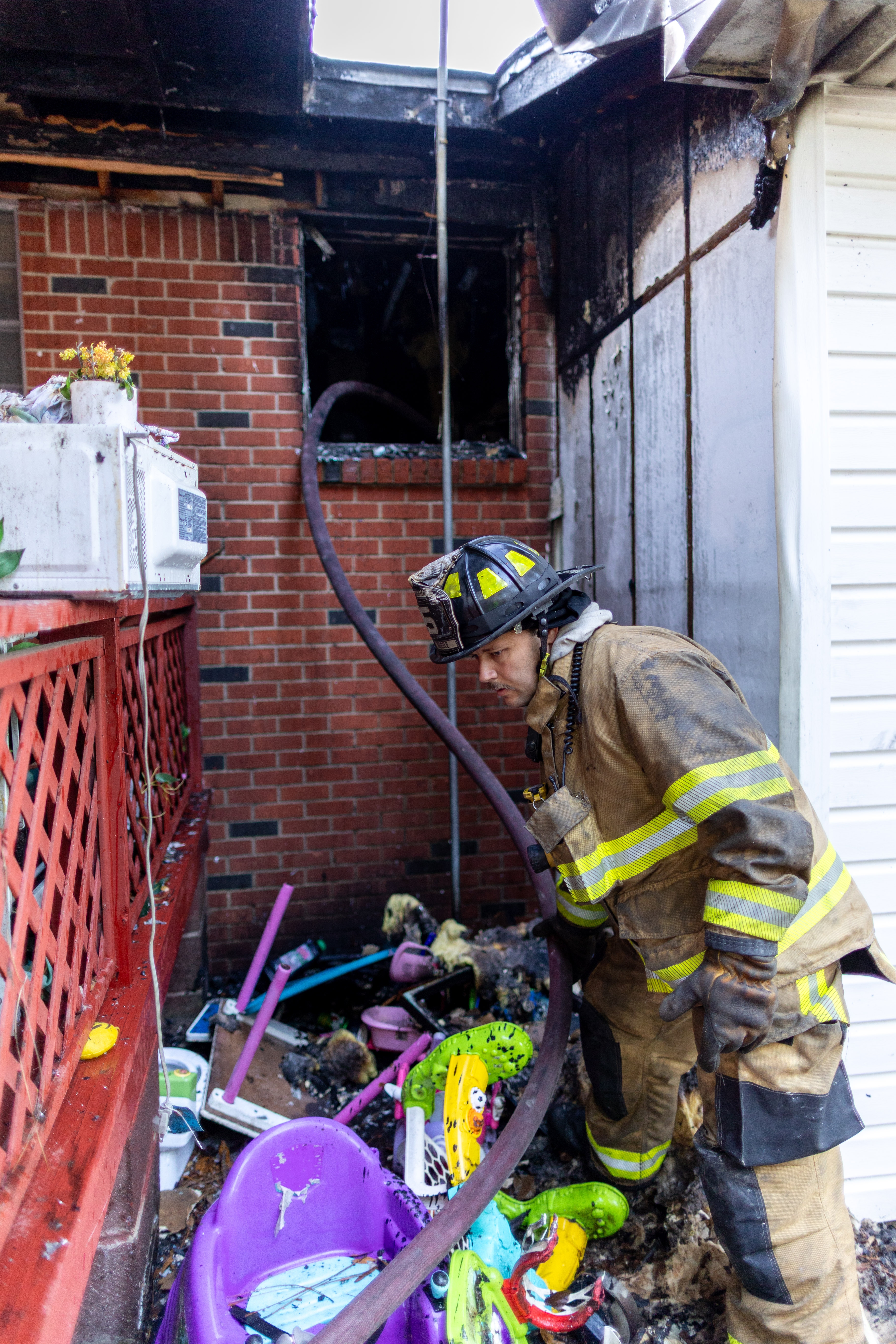 Firefighter works at scene of residential fire